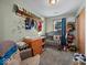 Charming Bedroom with soft green walls, a wooden crib, dresser, and plenty of storage, perfect for a growing Gathering at 619 Fair Ave, Shelbyville, IN 46176