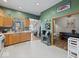 Spacious kitchen featuring wood cabinets and an adjacent dining area with access to a cozy living space at 619 Fair Ave, Shelbyville, IN 46176