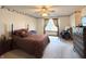 Cozy bedroom with a queen-size bed, dresser, and ceiling fan at 650 Davis Ct, Indianapolis, IN 46234