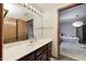 Bright bathroom with single sink and view into bedroom at 7425 Cherryhill Dr, Indianapolis, IN 46254