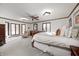 Bright bedroom with a king-size bed and bay windows at 7425 Cherryhill Dr, Indianapolis, IN 46254