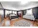Bedroom with hardwood floors, dark walls, and a daybed at 7425 Cherryhill Dr, Indianapolis, IN 46254