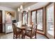 Bright breakfast nook with wood table and chairs, overlooking the backyard at 7425 Cherryhill Dr, Indianapolis, IN 46254