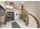 Elegant entryway featuring a curved staircase and tile flooring at 7425 Cherryhill Dr, Indianapolis, IN 46254