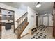 Bright entryway with staircase, shoe storage, and kitchen view at 7425 Cherryhill Dr, Indianapolis, IN 46254