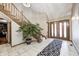 Spacious entry with curved staircase, tiled floors, and large doors at 7425 Cherryhill Dr, Indianapolis, IN 46254
