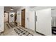 Convenient entryway with tile flooring, refrigerator, and coat rack at 7425 Cherryhill Dr, Indianapolis, IN 46254