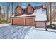 Attached two-car brick garage with dormer windows and snow-covered roof at 7425 Cherryhill Dr, Indianapolis, IN 46254