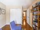 Cozy bedroom with hardwood floors, closet, and a stylish accent chair at 7629 Farm View W Cir, Indianapolis, IN 46256