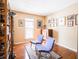 Inviting bedroom featuring a large window, hardwood floors, and eclectic decor with accent chairs at 7629 Farm View W Cir, Indianapolis, IN 46256