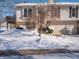 Brick and vinyl siding home with a snow-covered front yard and attached garage at 7629 Farm View W Cir, Indianapolis, IN 46256