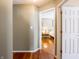 Hallway leading to bedroom with hardwood floors and white trim at 7629 Farm View W Cir, Indianapolis, IN 46256