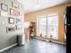 Bright kitchen with stainless steel trash receptacle, large window, and tile flooring at 7629 Farm View W Cir, Indianapolis, IN 46256