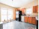 Bright kitchen with stainless steel dishwasher, black refrigerator, and tile flooring at 7629 Farm View W Cir, Indianapolis, IN 46256