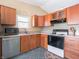 Kitchen featuring stainless steel dishwasher, black range top oven, and tile flooring at 7629 Farm View W Cir, Indianapolis, IN 46256