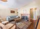 Cozy living room features a fireplace, hardwood floors, and comfortable seating at 7629 Farm View W Cir, Indianapolis, IN 46256