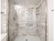 Close-up of glass-enclosed shower with elegant tile and modern fixtures at 7629 Farm View W Cir, Indianapolis, IN 46256