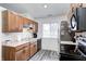 Efficient kitchen with wood cabinets and black appliances at 8007 Bryan Dr, Indianapolis, IN 46227