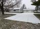 Ranch-style home with attached two-car garage and snow-covered driveway at 8231 Spring Valley Dr, Plainfield, IN 46168