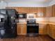 Modern kitchen with black appliances and oak cabinets at 8231 Spring Valley Dr, Plainfield, IN 46168