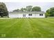 Expansive backyard features meticulously manicured lawn and a house with white siding at 901 N 700 W, Greenfield, IN 46140