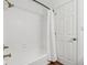 Clean bathroom with white tub and shower, and gold fixtures at 901 N 700 W, Greenfield, IN 46140