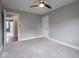 Carpeted bedroom with ceiling fan, offering views to an adjacent space and a white door at 901 N 700 W, Greenfield, IN 46140