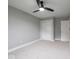 Spacious bedroom with plush carpeting, featuring a ceiling fan, closet and a white door at 901 N 700 W, Greenfield, IN 46140