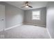 Cozy bedroom with neutral carpeting, a ceiling fan, a window view, and a white door at 901 N 700 W, Greenfield, IN 46140