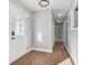 Bright entryway with hardwood floors, a chandelier, and a white door with a glass insert at 901 N 700 W, Greenfield, IN 46140
