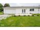 Desirable home exterior featuring an attached garage, outdoor patio, and manicured landscaping at 901 N 700 W, Greenfield, IN 46140