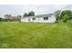 Well-maintained white home exterior featuring a lush green lawn and attached garage at 901 N 700 W, Greenfield, IN 46140