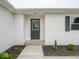 Inviting front door entrance featuring clean lines, decorative window, and minimalist landscaping at 901 N 700 W, Greenfield, IN 46140