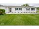 Attractive front entrance with well-kept lawn, updated landscaping, and decorative door at 901 N 700 W, Greenfield, IN 46140