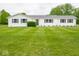 Charming one-story home with white siding, black shutters, and a lush green front lawn at 901 N 700 W, Greenfield, IN 46140