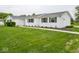 Well-maintained front yard of house with green grass, neatly trimmed hedges, and a sidewalk at 901 N 700 W, Greenfield, IN 46140