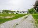 Charming one-story home with a gravel driveway and well-manicured lawn and mature trees at 901 N 700 W, Greenfield, IN 46140