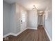 Inviting hallway with wood-look floors, a decorative front door, and neutral paint at 901 N 700 W, Greenfield, IN 46140
