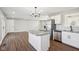Open concept kitchen with island, stainless steel appliances, and hardwood floors at 901 N 700 W, Greenfield, IN 46140