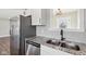 Modern kitchen with double sink, granite countertops, and stainless steel appliances at 901 N 700 W, Greenfield, IN 46140