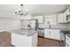 Bright kitchen with granite island, white cabinets, and stainless steel appliances at 901 N 700 W, Greenfield, IN 46140