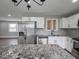 Bright kitchen with stainless appliances, granite counters, and wood floors at 901 N 700 W, Greenfield, IN 46140