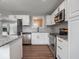 This modern kitchen features granite counters and stainless appliances with updated cabinets at 901 N 700 W, Greenfield, IN 46140