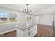 Eat-in kitchen with island, hardwood floors, and access to backyard at 901 N 700 W, Greenfield, IN 46140