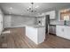 Kitchen features wood floors, kitchen island, stainless appliances, and lots of natural light at 901 N 700 W, Greenfield, IN 46140