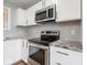 Close up of updated kitchen featuring granite counters and stainless appliances at 901 N 700 W, Greenfield, IN 46140