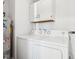 Bright laundry room with washer, dryer, and overhead cabinets at 901 N 700 W, Greenfield, IN 46140