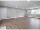 Clean, well-lit living room featuring wood floors, neutral walls, and ample space at 901 N 700 W, Greenfield, IN 46140