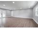 Open living room featuring wood floors, neutral paint, and a large window for natural light at 901 N 700 W, Greenfield, IN 46140