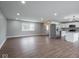 Bright, open living space with wood floors, recessed lighting, and seamless transition to the kitchen at 901 N 700 W, Greenfield, IN 46140